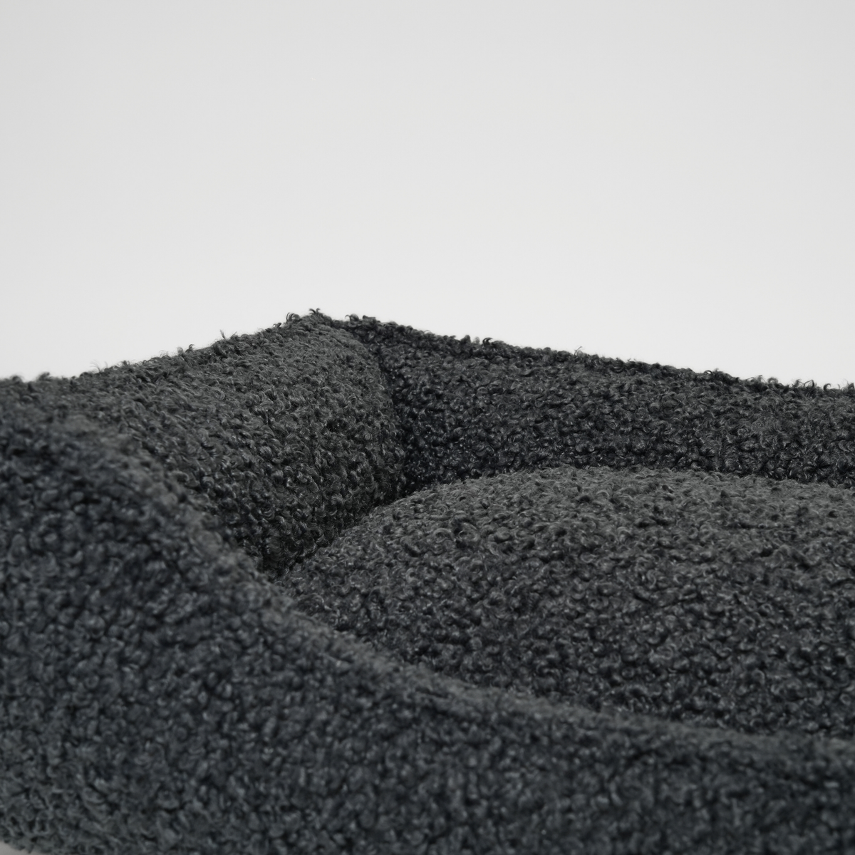 Close-up of the bolster and cushion in the storm curly bouclé dog bed