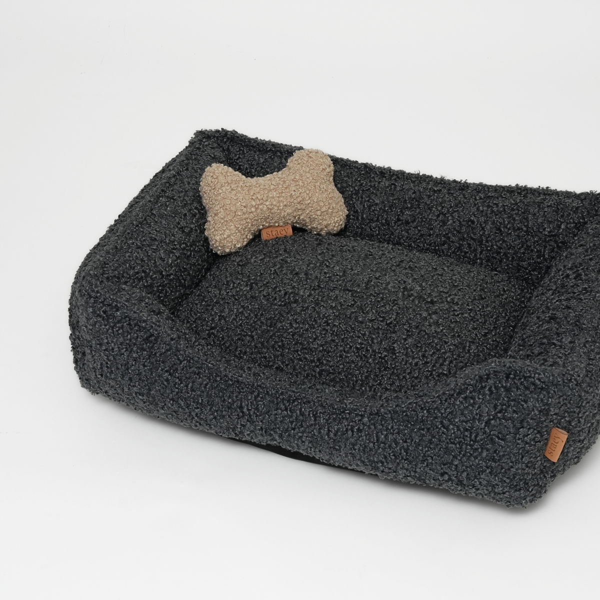The storm curly bouclé dog bed with a bone-shaped cushion