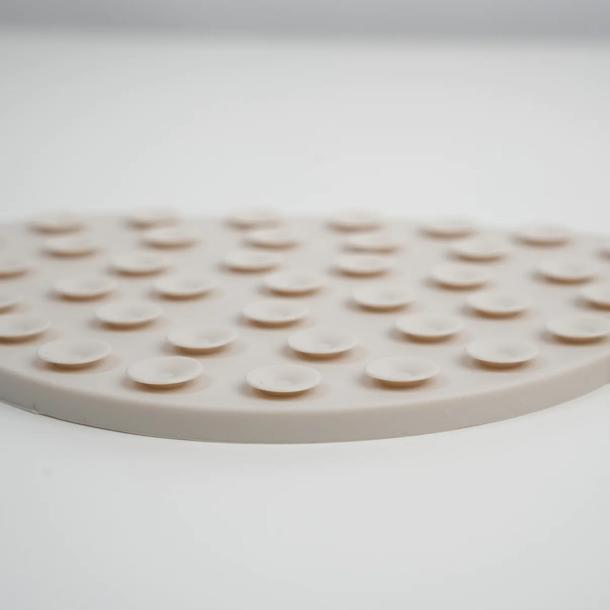 Close-up of the suction cups on the back of the cream licking mat