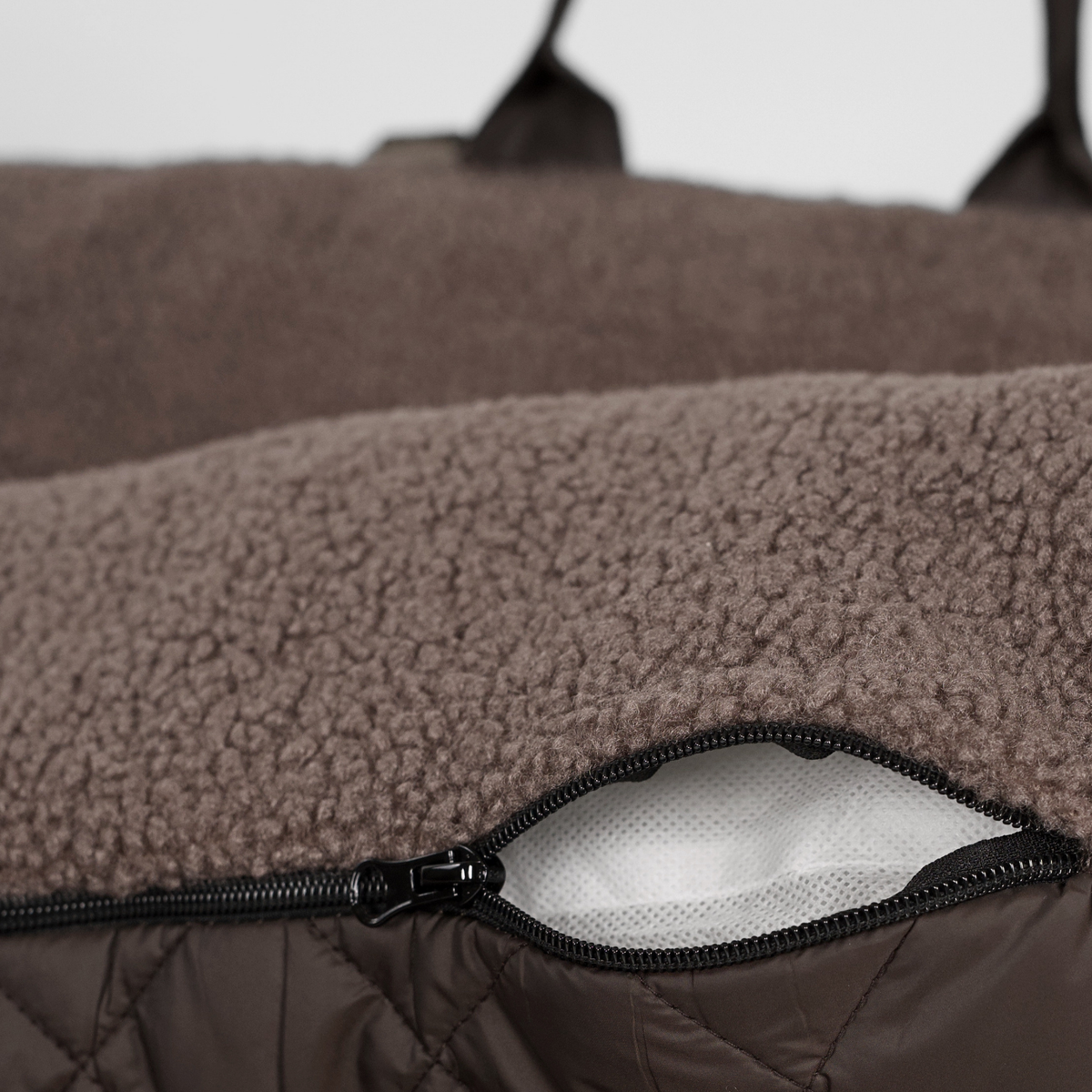 Close-up of the zip on the removable cover of the Clara teddy car seat