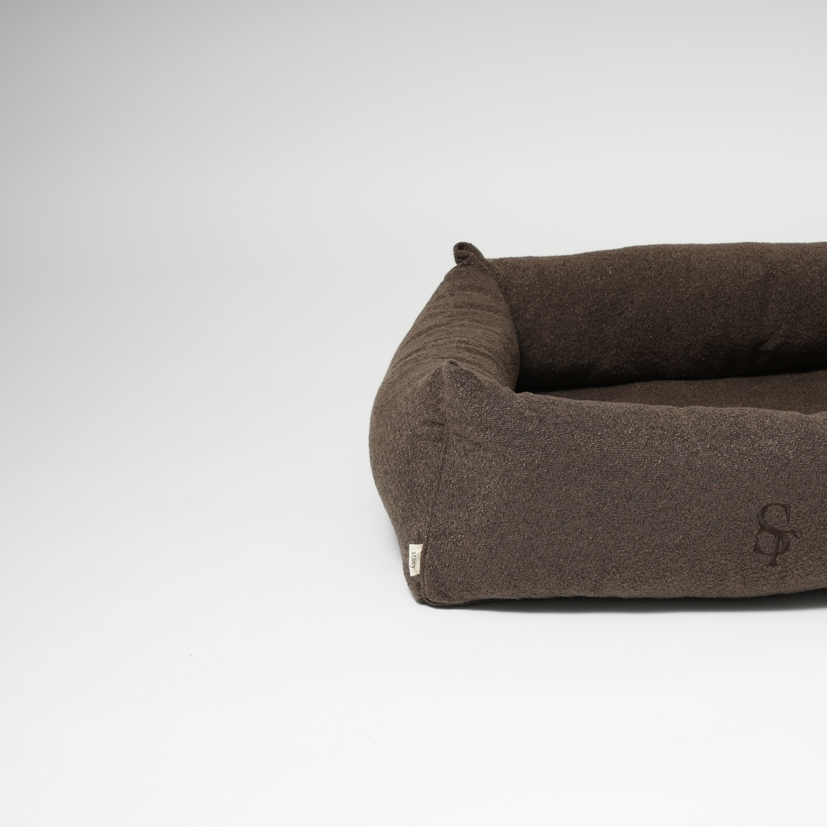 The espresso rectangular dog bed seen from the side