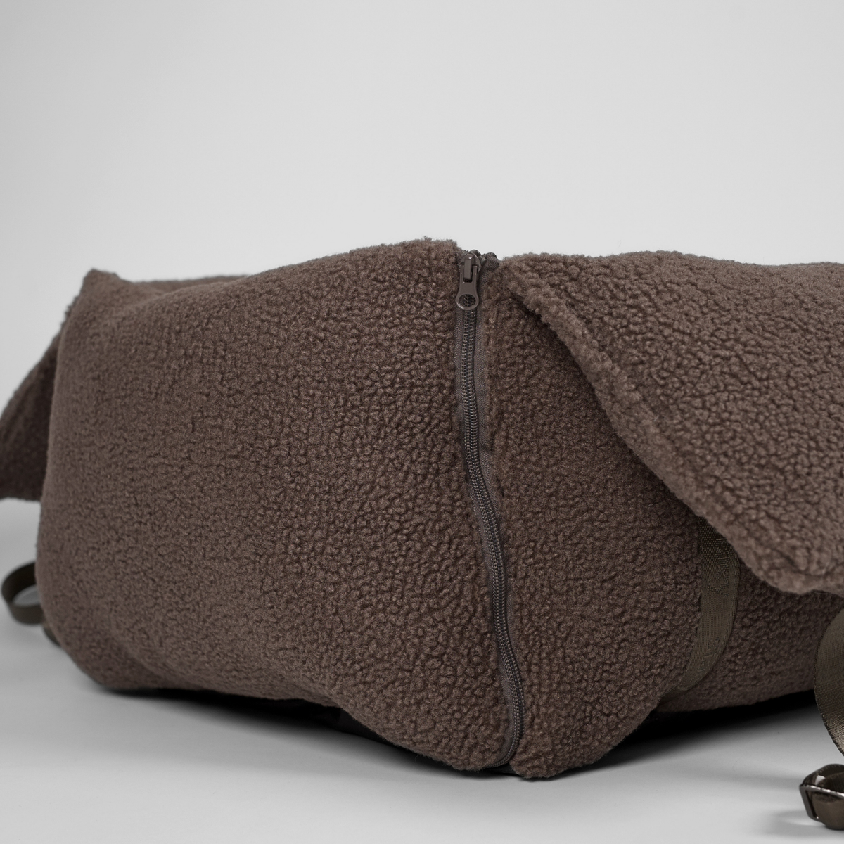 The Clara teddy car seat partly unzipped, seen from the side