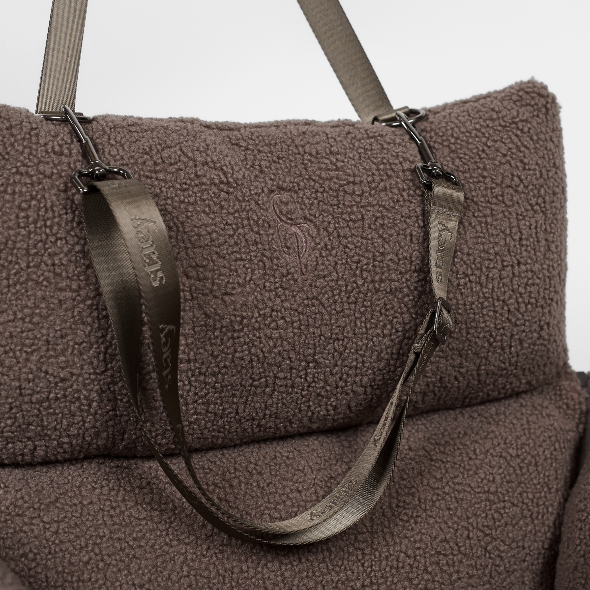 The Clara teddy carrier bag with its shoulder strap attached