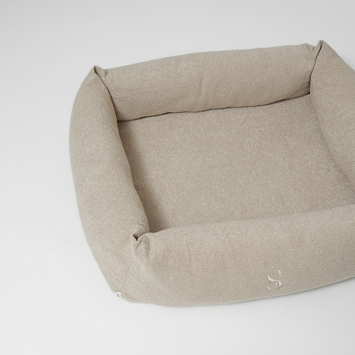 The oat bouclé rectangular dog bed seen from above