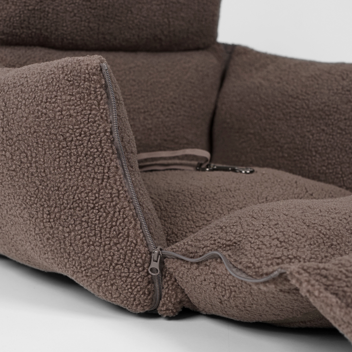 Close-up of the zip that opens the Clara teddy car seat cover