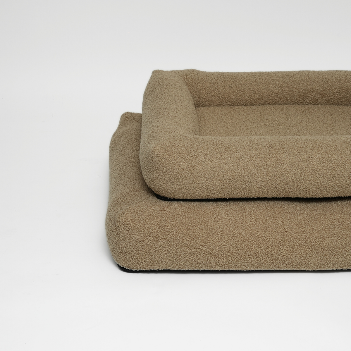 Two moss curly bouclé dog beds stacked