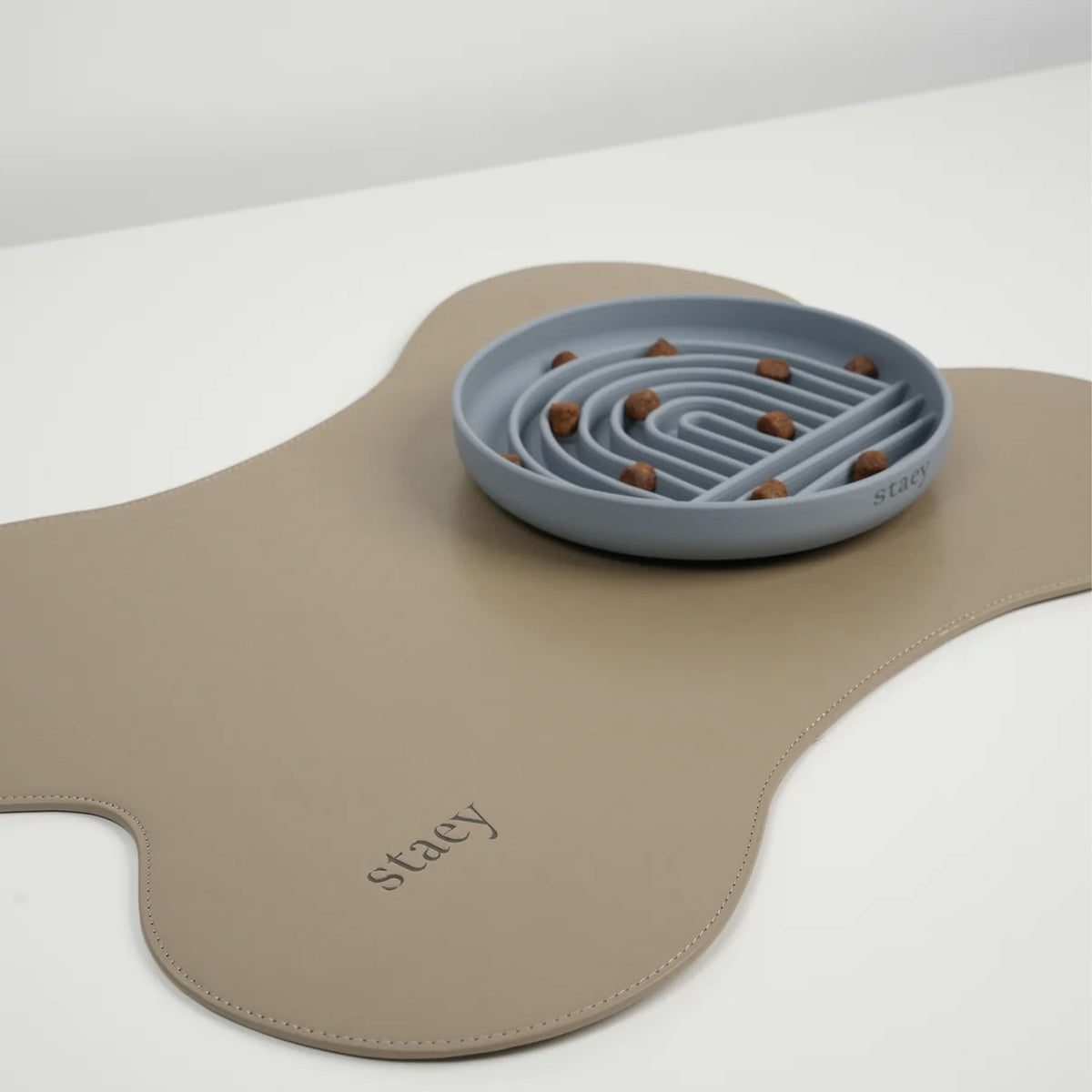 The stone slowfeeder bowl on a taupe silicone feeding mat