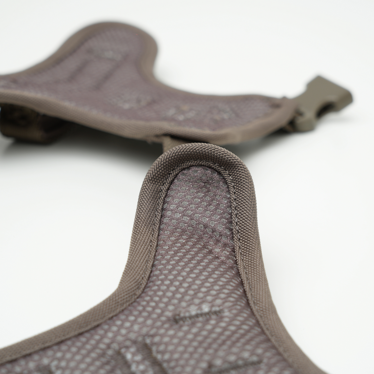 Close-up of the mesh lining and buckle on the taupe Elma harness
