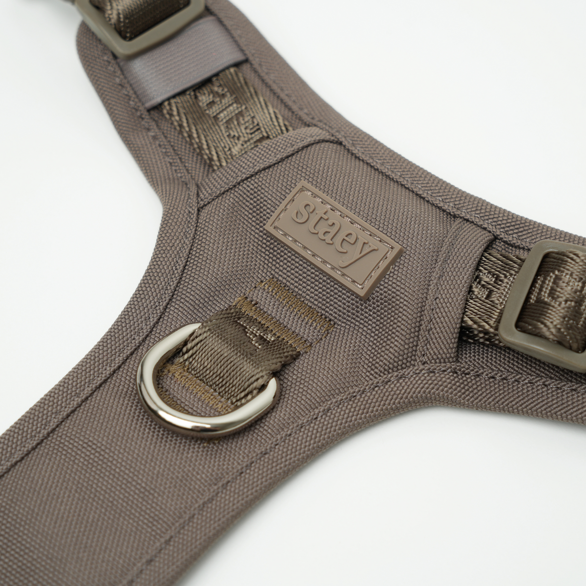 Close-up of the D-ring and Staey labels on the taupe Elma harness
