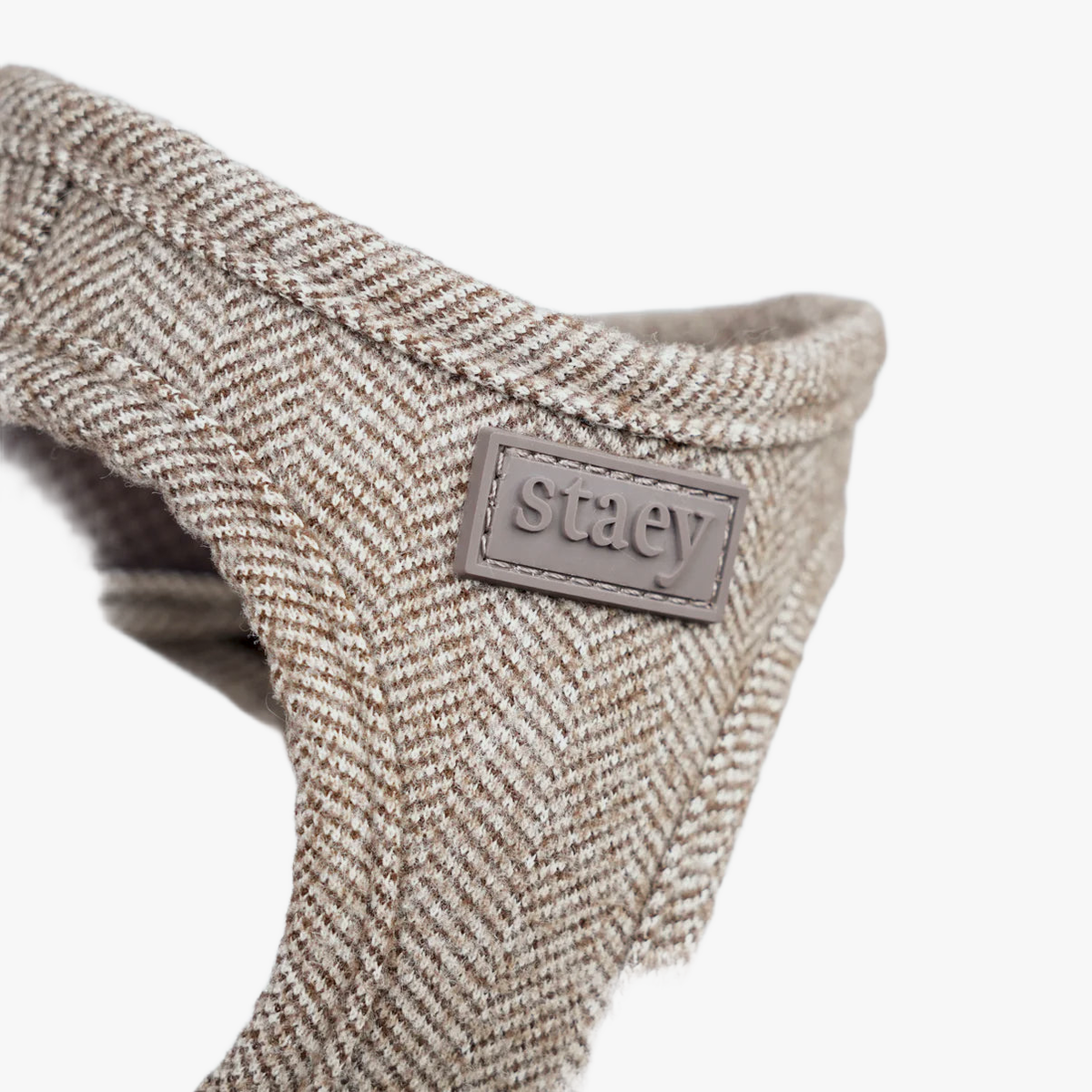 Close-up of the Staey label on the oat Saga step-in harness