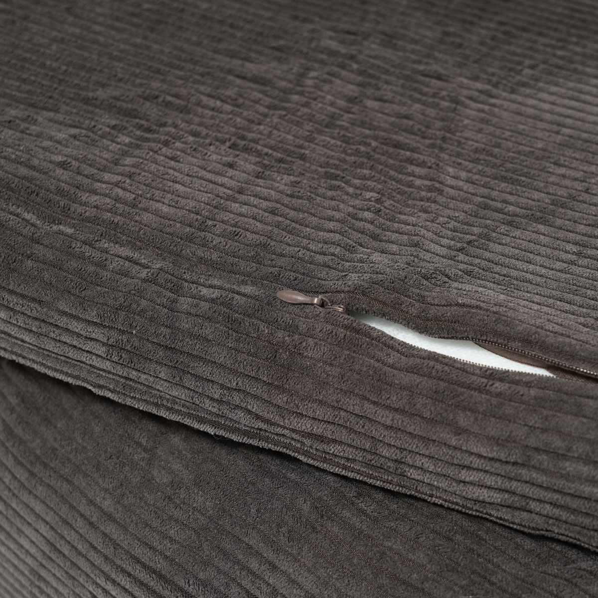 Close-up of the zip on the removable cover of the charcoal corduroy dog bed