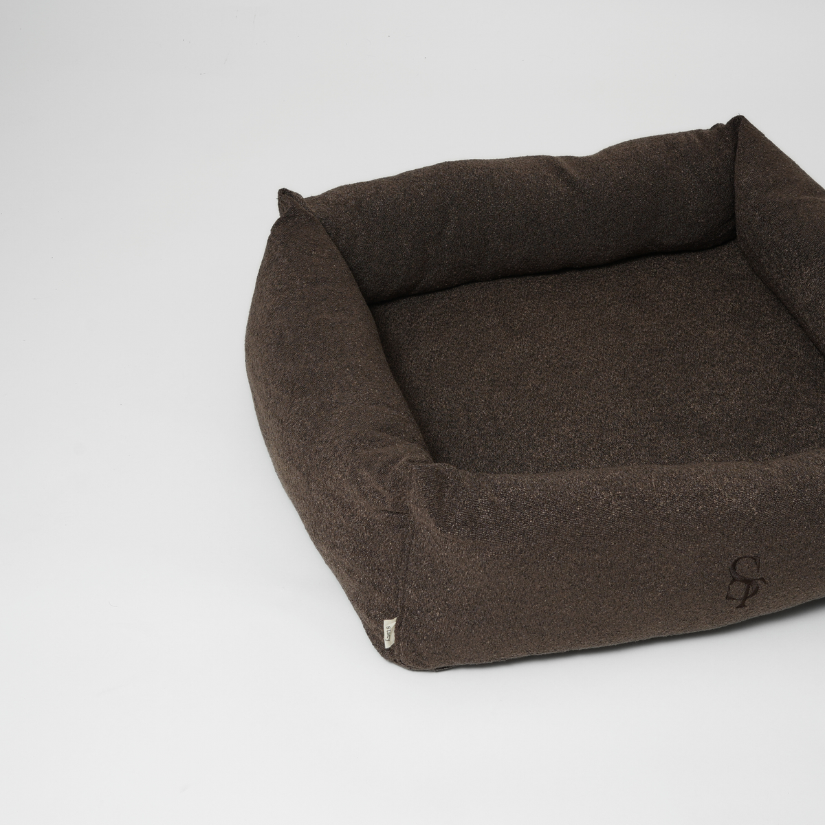 The espresso rectangular dog bed seen at an angle