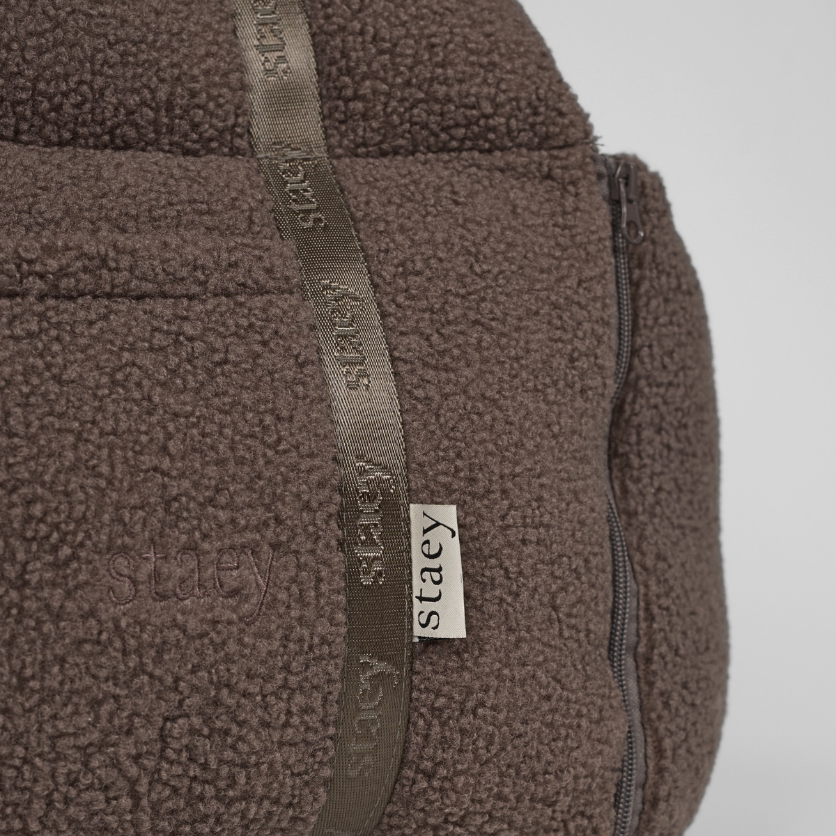 Close-up of the Staey label on the webbing of the Clara teddy car seat
