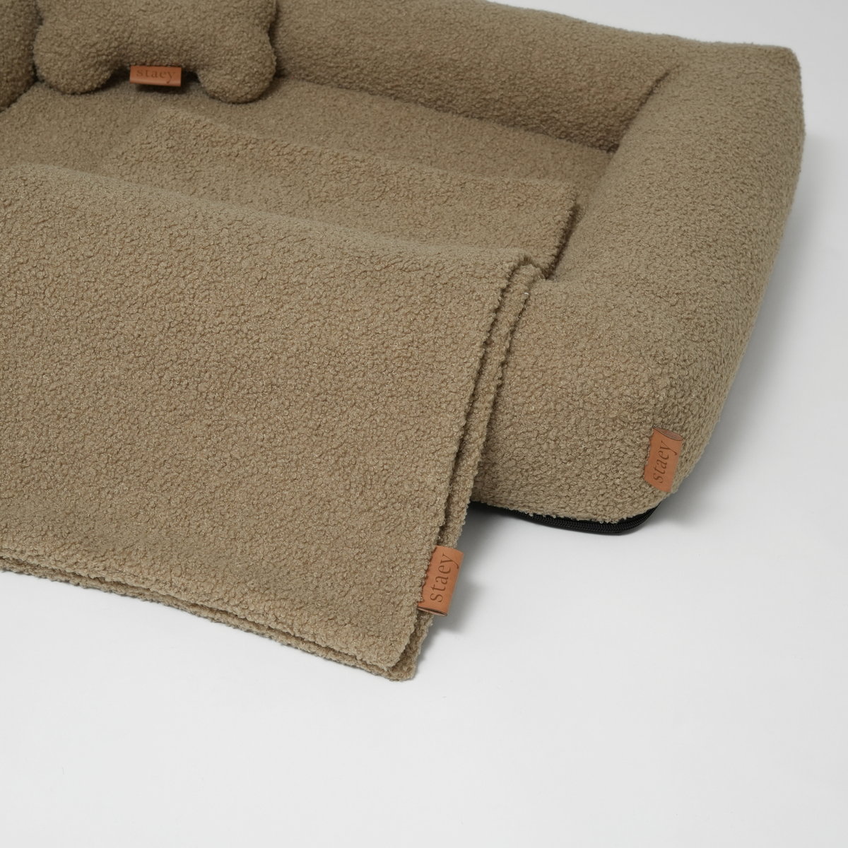 The moss curly bouclé dog bed with a bone cushion and a matching mat
