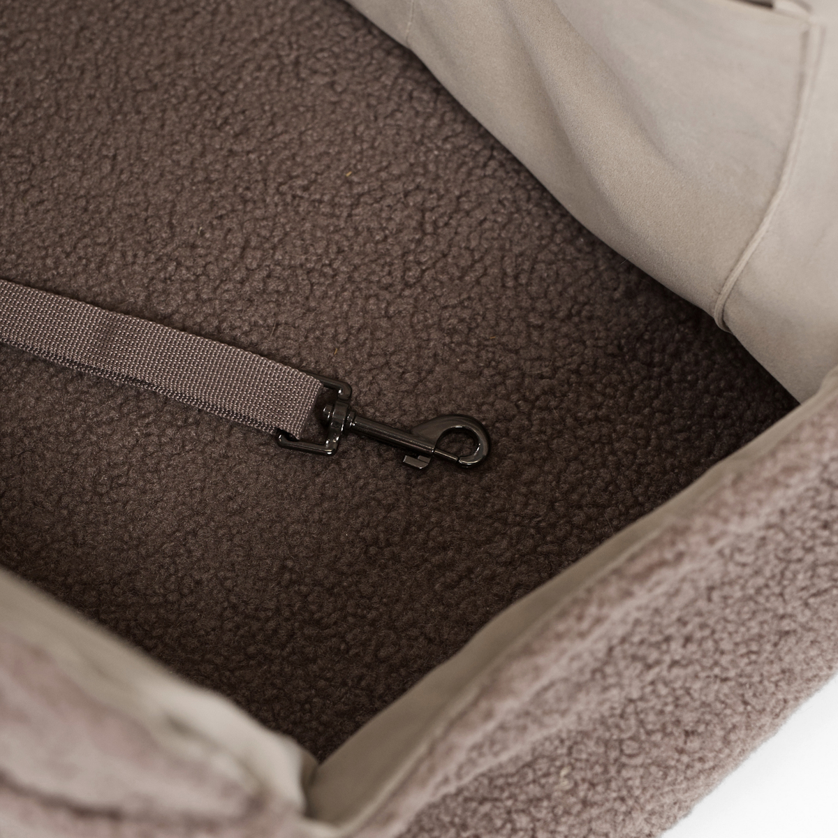 Close-up of the safety strap inside the Clara teddy car seat