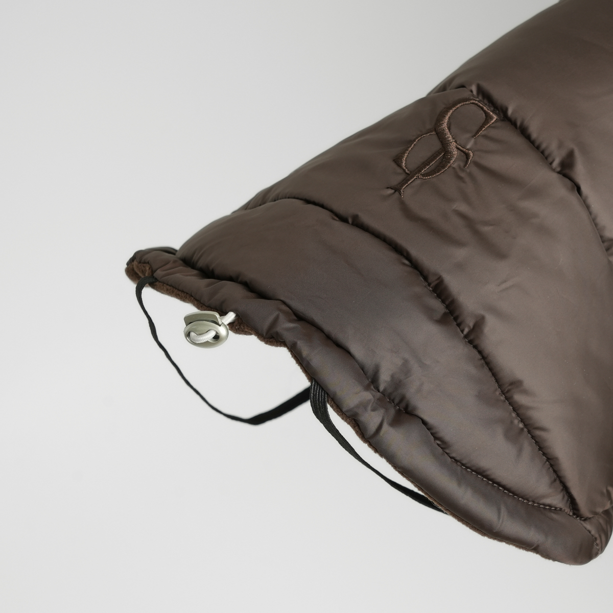 Close-up of the hood and drawcord on the espresso quilted dog coat