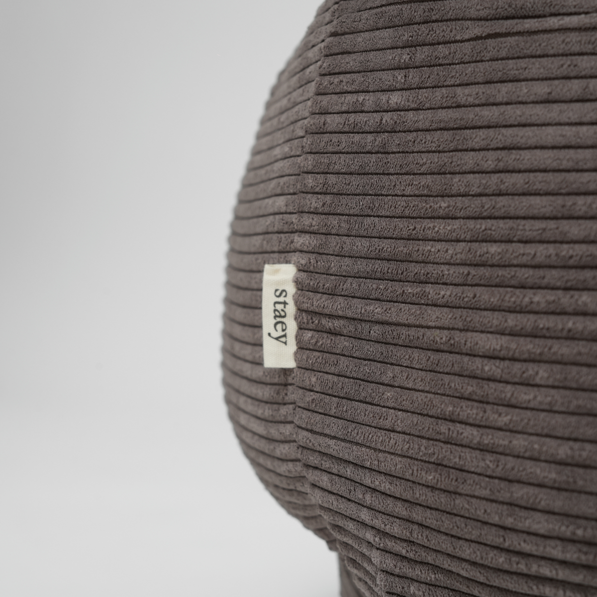 Close-up of the Staey label on the taupe corduroy dog bed
