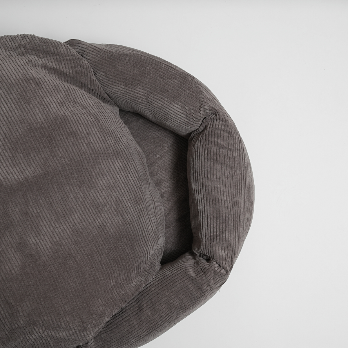 The taupe corduroy dog bed seen from the side