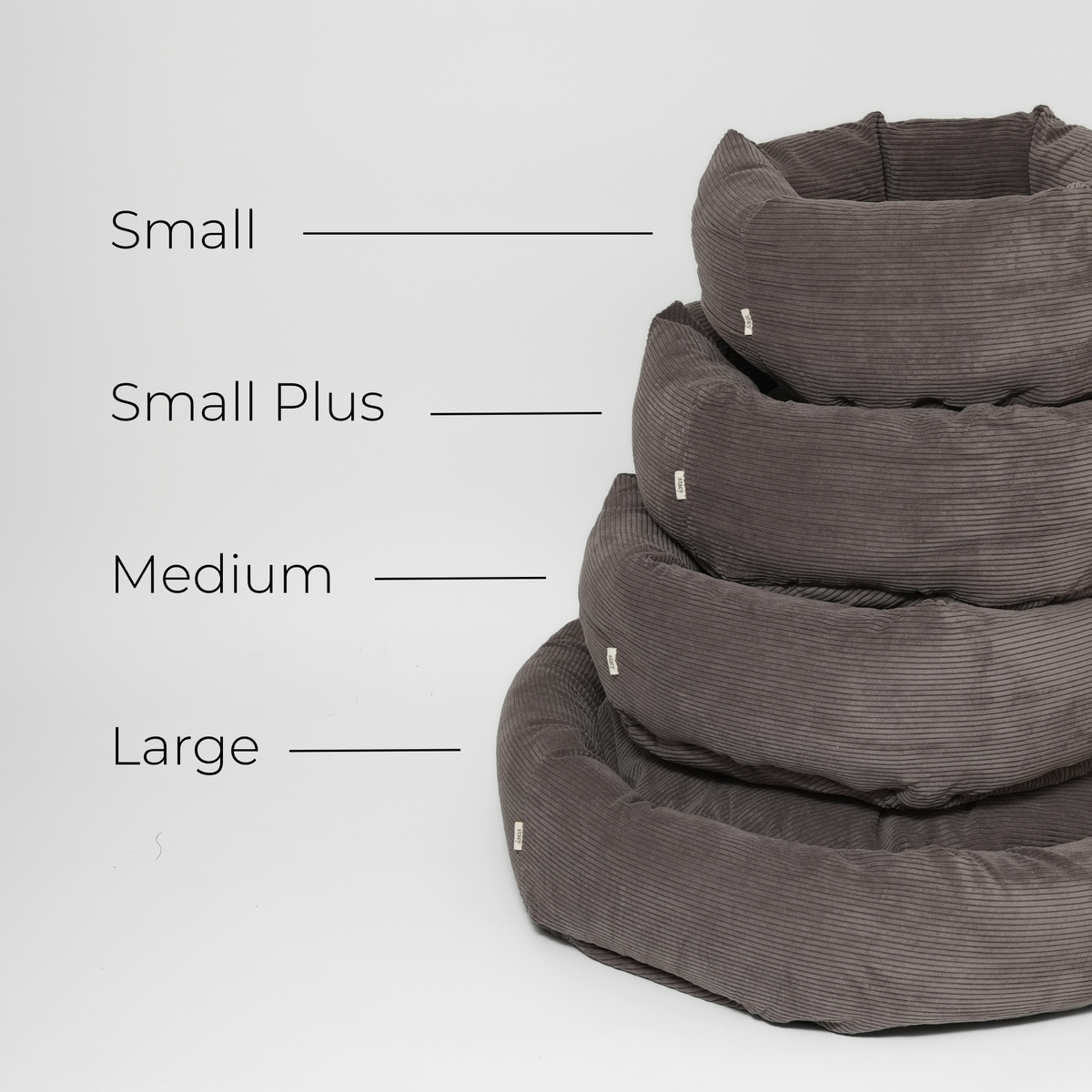 Size guide showing the taupe corduroy dog bed in Small, Small Plus, Medium and Large, stacked