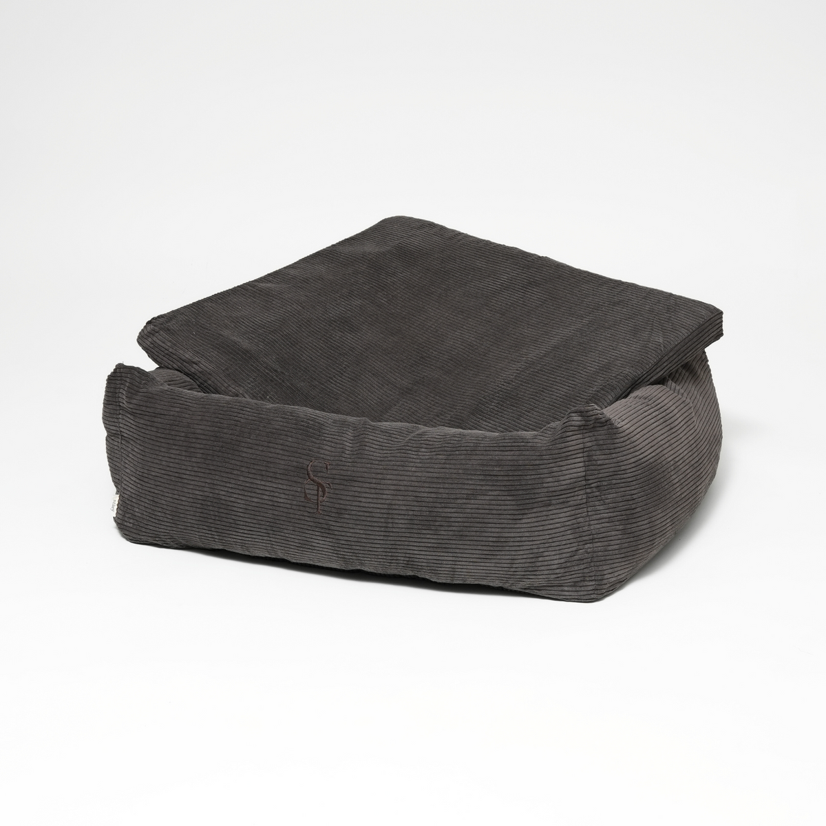 The charcoal corduroy rectangular dog bed with its cushion propped up