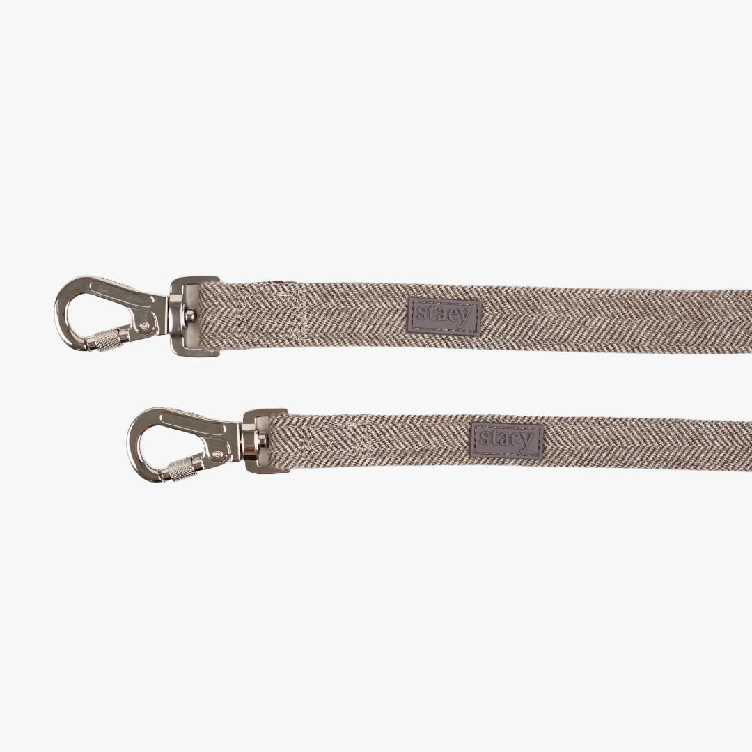 Two mocca Elma leashes with their steel snap hooks and Staey labels